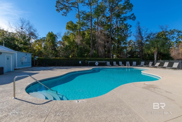 pool featuring a patio and fence