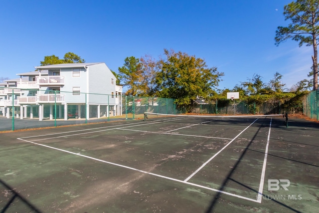 view of tennis court featuring fence