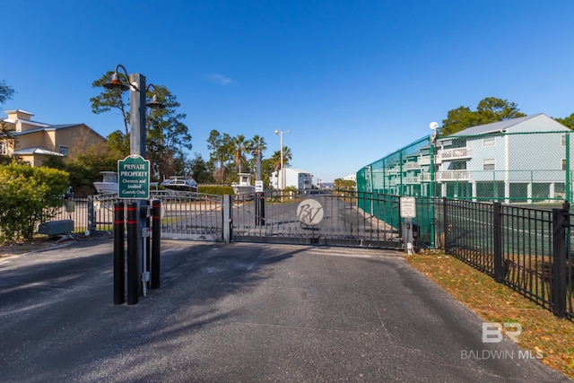 view of street featuring a gate, street lighting, and a gated entry