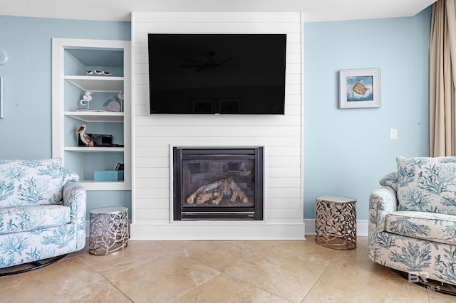 tiled living room featuring built in shelves and a fireplace