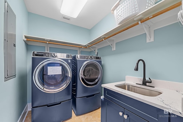 laundry area with washer and dryer, visible vents, a sink, and cabinet space