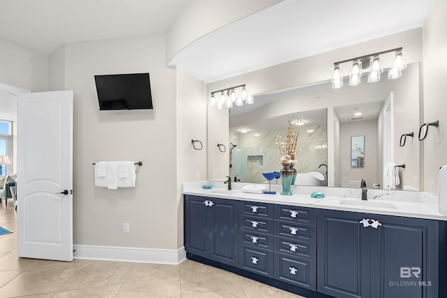 full bathroom featuring a marble finish shower, double vanity, a sink, baseboards, and tile patterned floors