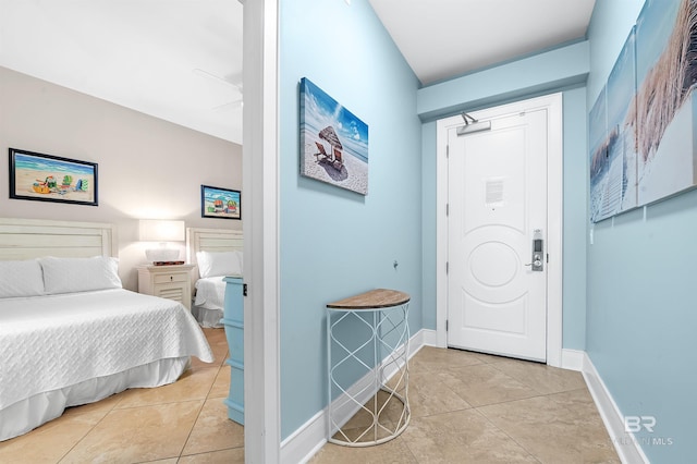 entryway with light tile patterned floors and baseboards