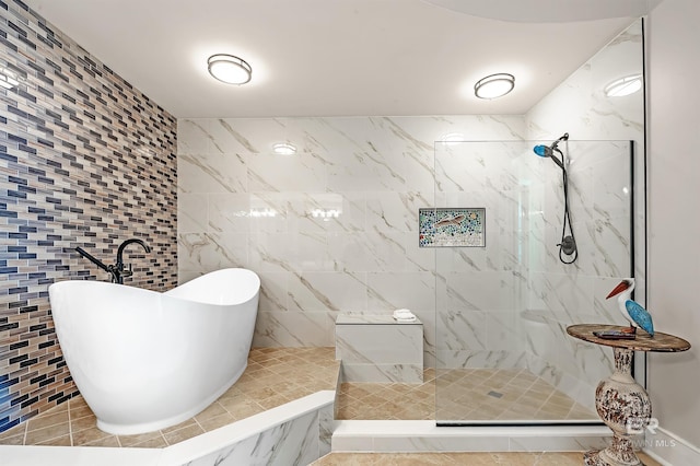 bathroom featuring a walk in shower and a freestanding bath