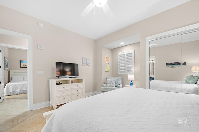 bedroom featuring ceiling fan, baseboards, and light tile patterned floors