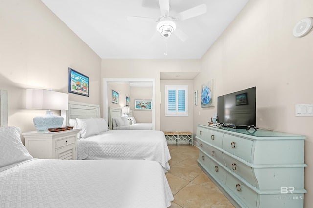 bedroom featuring ceiling fan, a closet, and light tile patterned flooring