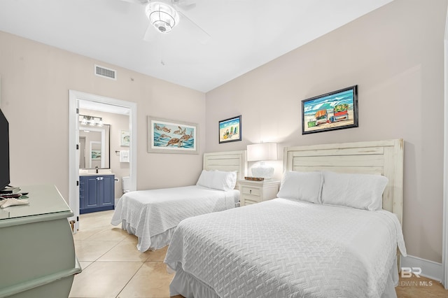 bedroom with light tile patterned floors, visible vents, baseboards, a ceiling fan, and ensuite bath