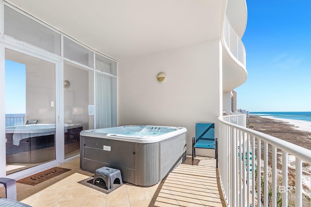 balcony with a water view and a beach view