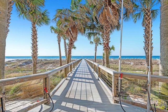 surrounding community with a water view and a view of the beach