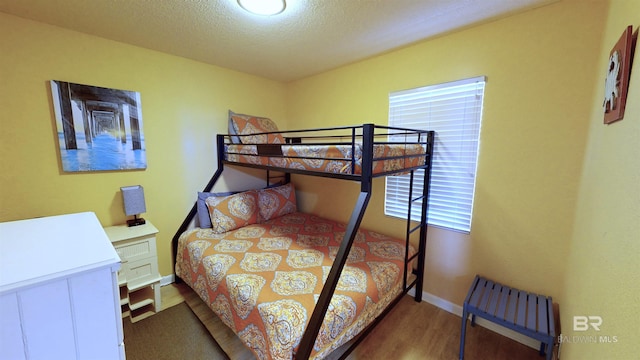 bedroom featuring a textured ceiling and hardwood / wood-style flooring