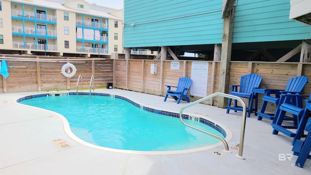 view of swimming pool with a patio