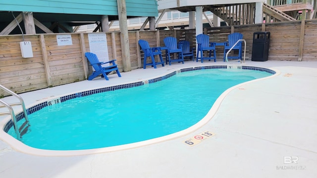 view of swimming pool with a patio area