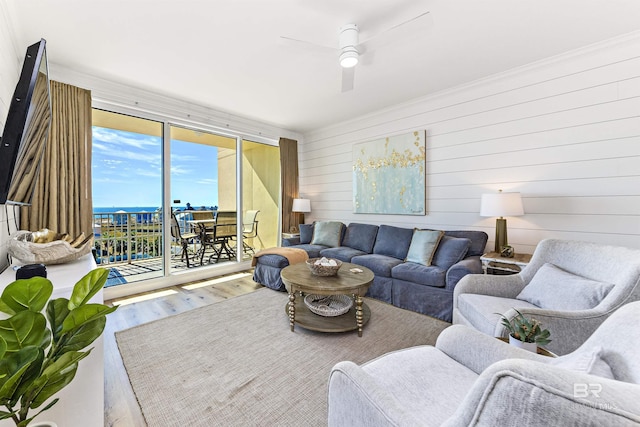 453 Dune Dr Unit 404, Gulf Shores, AL 36542 - living room with wood finished floors, ceiling fan, crown molding, and wood walls