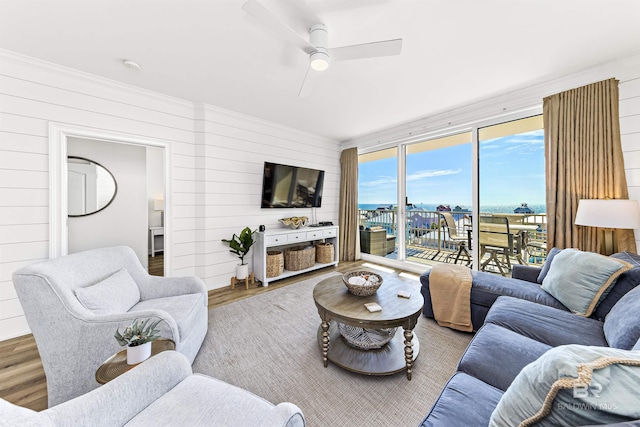 453 Dune Dr Unit 404, Gulf Shores, AL 36542 - living area with wood finished floors, wood walls, a ceiling fan, and ornamental molding