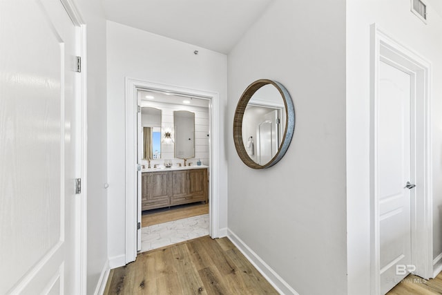 453 Dune Dr Unit 404, Gulf Shores, AL 36542 - corridor featuring light wood-style flooring and baseboards