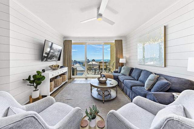 453 Dune Dr Unit 404, Gulf Shores, AL 36542 - living room with wooden walls, a ceiling fan, wood finished floors, and ornamental molding