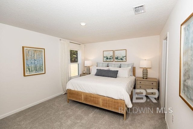 bedroom featuring carpet floors, baseboards, visible vents, and a textured ceiling