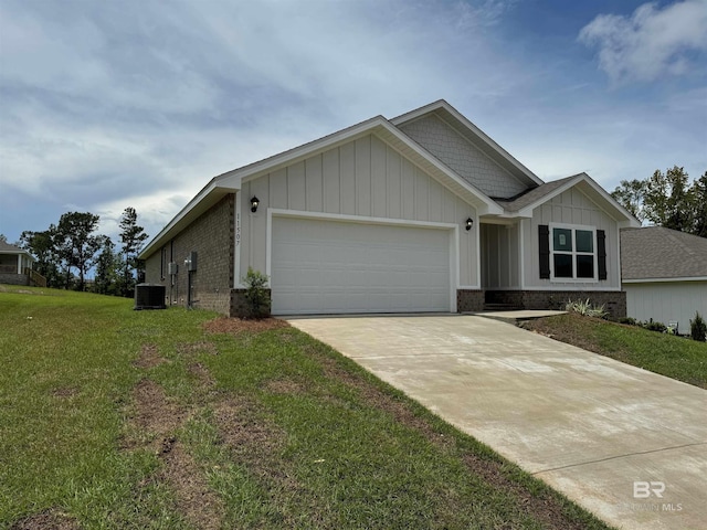 view of front of property with a front lawn, central AC, and a garage