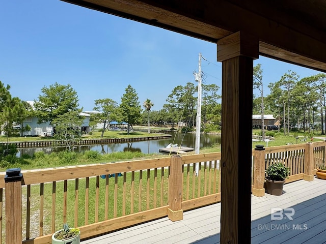 wooden terrace featuring a water view