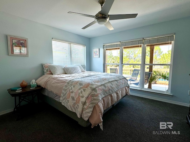 carpeted bedroom featuring baseboards and ceiling fan