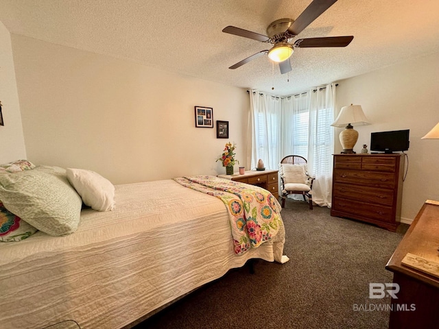 carpeted bedroom with a ceiling fan and a textured ceiling