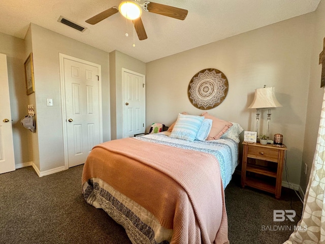 bedroom with visible vents, baseboards, carpet, and a ceiling fan