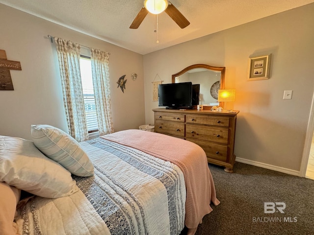 carpeted bedroom with a textured ceiling, a ceiling fan, and baseboards