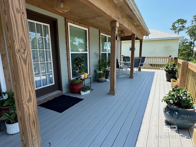 wooden deck featuring outdoor dining space