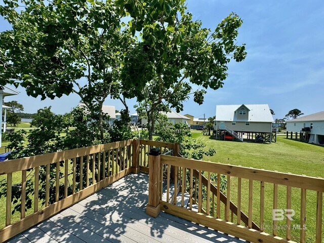 deck with stairway, a yard, and a residential view