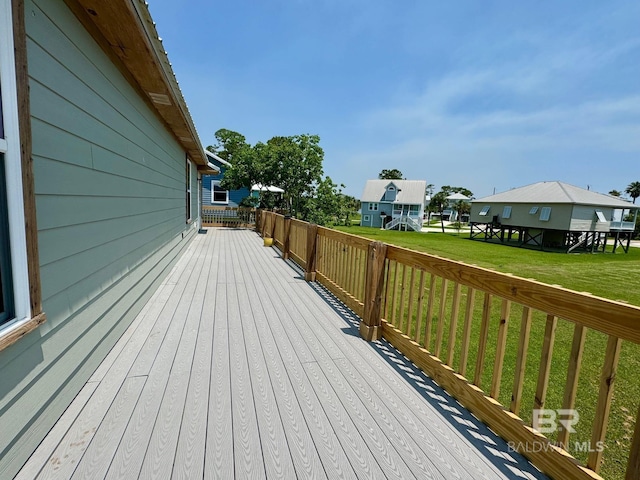 wooden deck featuring a residential view and a lawn