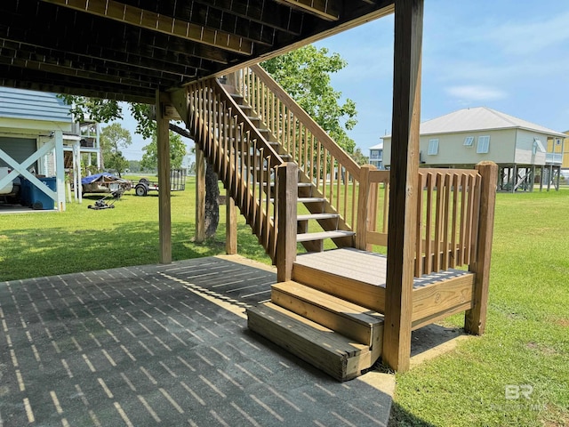 wooden terrace with stairway and a yard