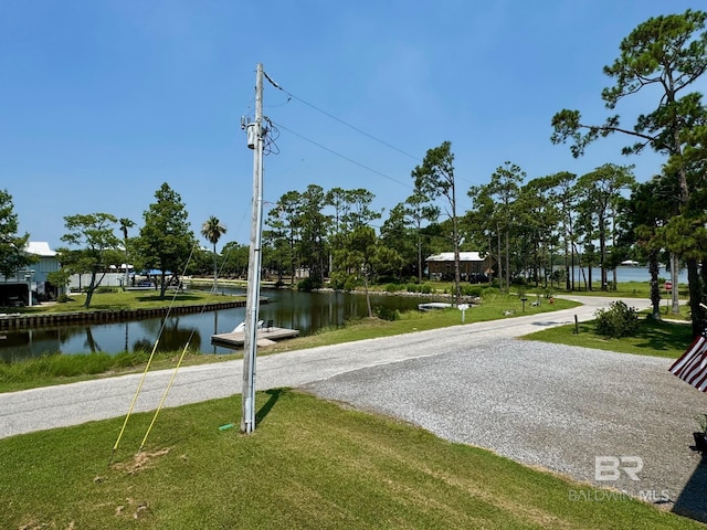 exterior space with a yard and a water view