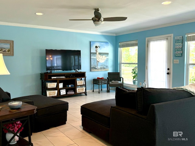 living area with ceiling fan, light tile patterned floors, baseboards, and ornamental molding