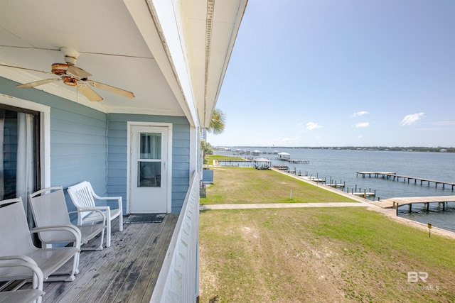 1872 W Beach Blvd Unit 206, Gulf Shores, AL 36542 - wooden terrace featuring a water view, a ceiling fan, a yard, and a dock