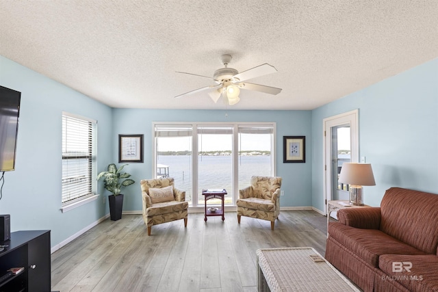 1872 W Beach Blvd Unit 206, Gulf Shores, AL 36542 - living area with ceiling fan, healthy amount of natural light, light wood-style floors, and a textured ceiling