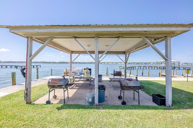 1872 W Beach Blvd Unit 206, Gulf Shores, AL 36542 - view of patio / terrace featuring a dock, a water view, boat lift, and area for grilling