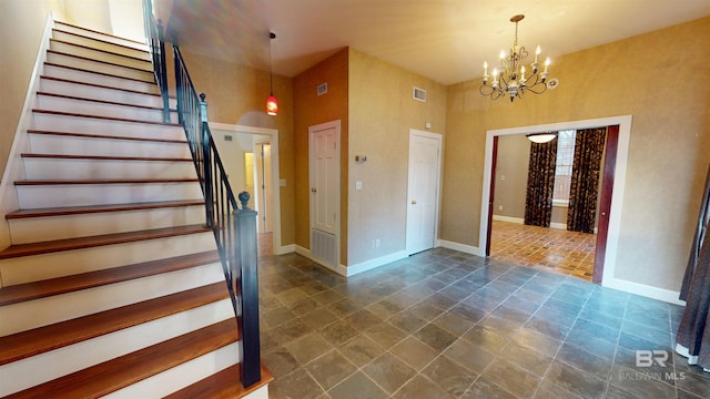 foyer with a notable chandelier and a high ceiling