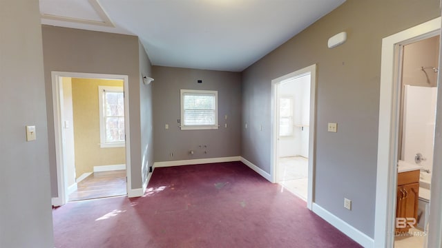 interior space with carpet floors and ensuite bathroom