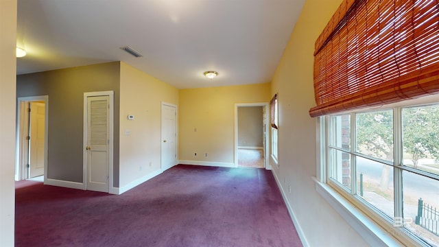 carpeted empty room featuring a healthy amount of sunlight