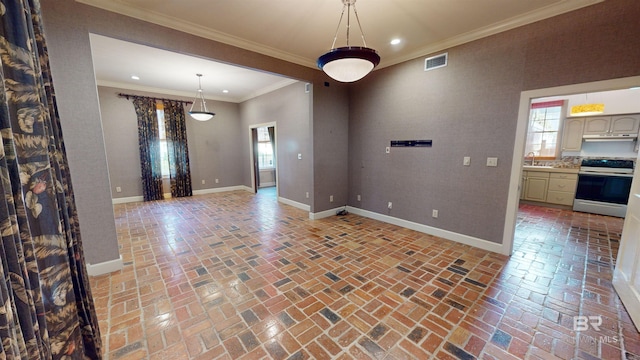 interior space featuring sink, plenty of natural light, and ornamental molding