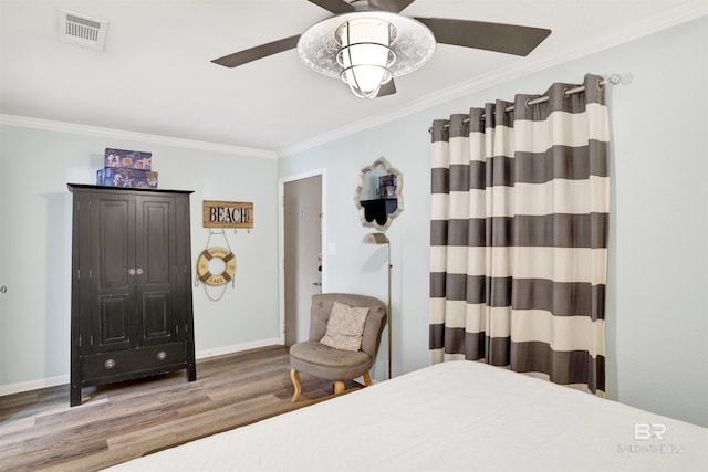 388 E Beach Blvd Unit A-2, Gulf Shores, AL 36542 - bedroom featuring visible vents, ornamental molding, wood finished floors, baseboards, and ceiling fan