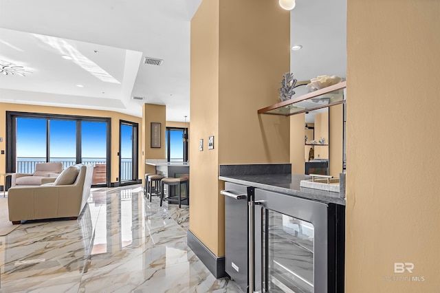 bar featuring marble finish floor, wine cooler, visible vents, and a bar