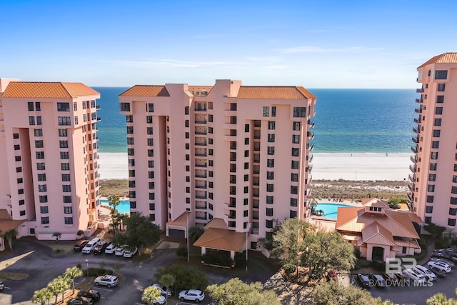 view of property with a view of the beach and a water view