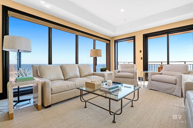 living area featuring a water view and recessed lighting