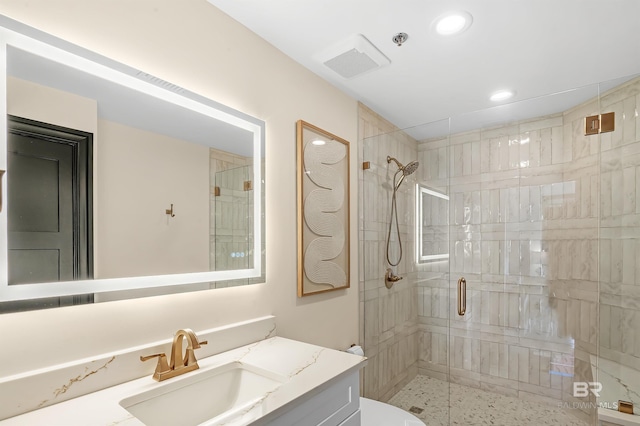 bathroom with a stall shower, vanity, visible vents, and recessed lighting