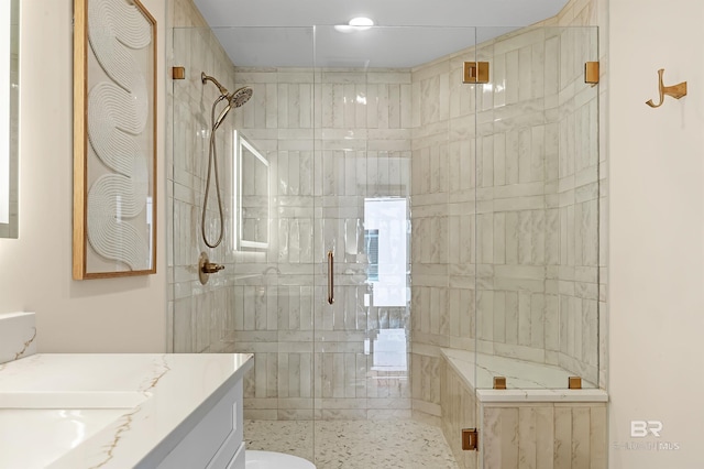 bathroom with a shower stall and vanity