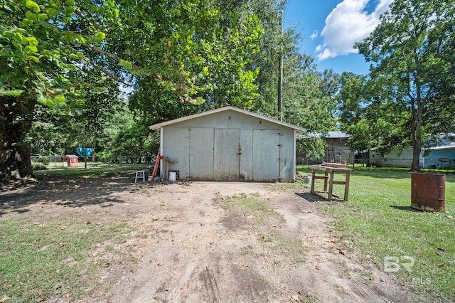 view of outdoor structure with a lawn