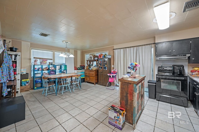 kitchen with a notable chandelier, black range with electric cooktop, hanging light fixtures, and light tile patterned floors