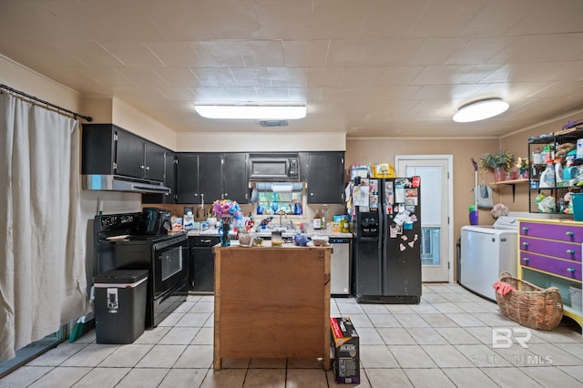 kitchen featuring light tile patterned flooring, independent washer and dryer, and black appliances