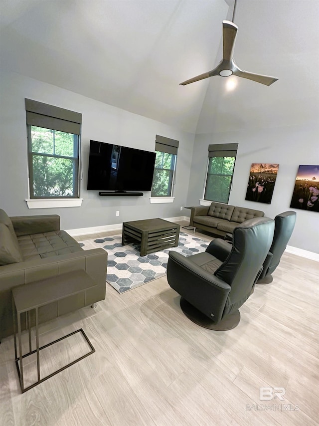 living room featuring ceiling fan, plenty of natural light, high vaulted ceiling, and light hardwood / wood-style flooring